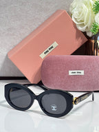 Designer round sunglasses with black frame and dark lenses