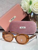 Round sunglasses with brown tortoiseshell frame and light tinted lenses