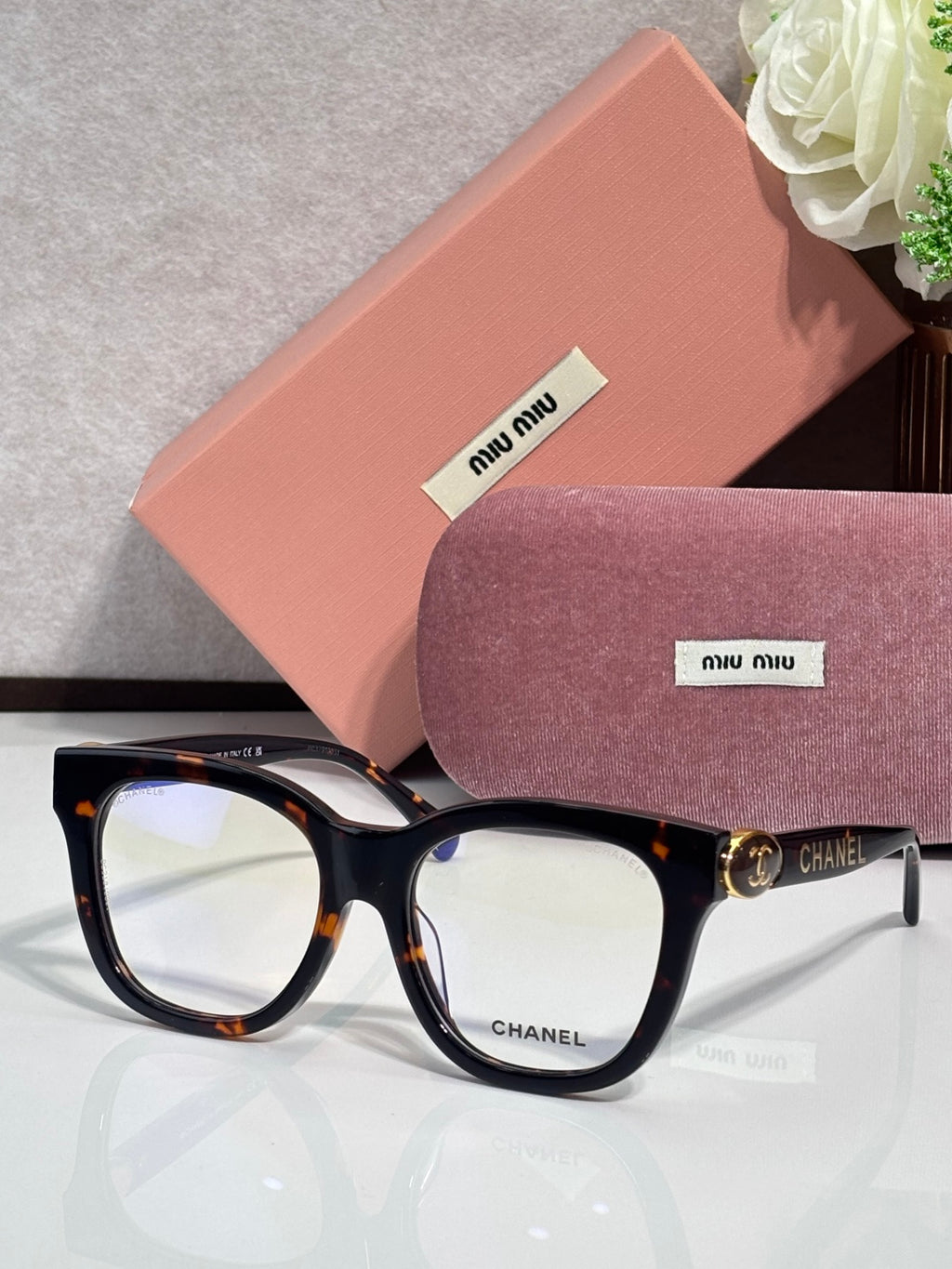 Chanel sunglasses with black frames and tortoise accents at the temples