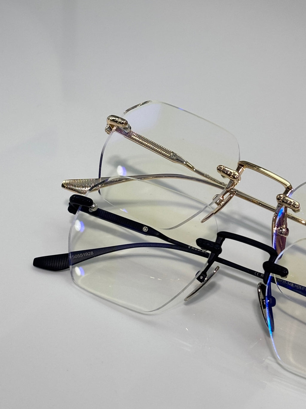 Assorted metal eyeglasses with clear lenses, gold and black frames shown