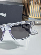 Chrome sunglasses front corner close-up with dark lens and ribbed temple tip