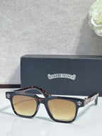 Tortoiseshell-accented sunglasses with chrome frame and gold fleur-de-lis details