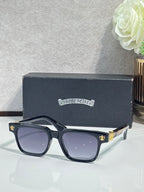 Dark blue-tinted sunglasses with chrome frame and gold fleur-de-lis hardware