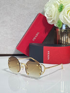 Prada round sunglasses with mirrored gold-tinted lenses and gold-tone frame