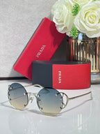 Prada round sunglasses with light blue lenses and silver-tone metal frame