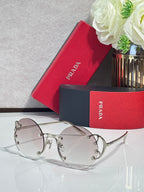 Prada round sunglasses with pale pink lenses and silver-tone metal frame