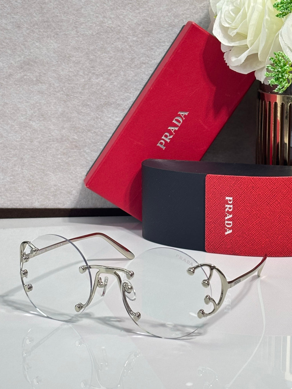 Prada round sunglasses with clear tinted lenses and silver-tone metal frame