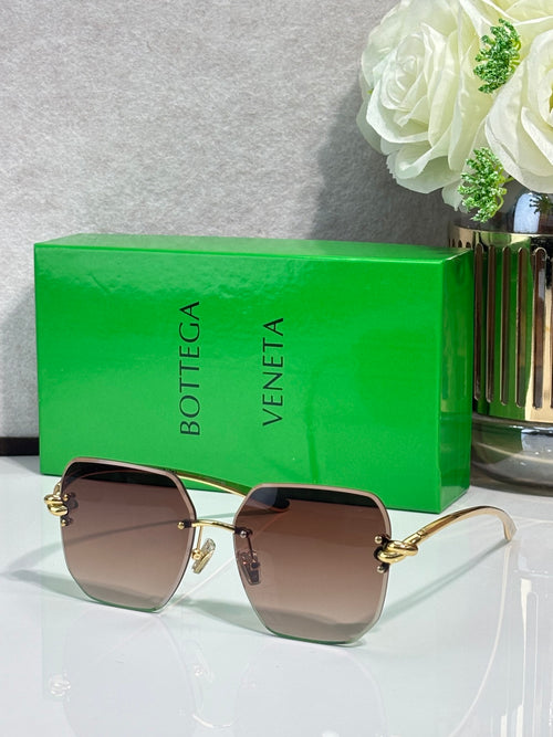 Bottega Veneta sunglasses with gold-tone metal frame and brown tinted lenses
