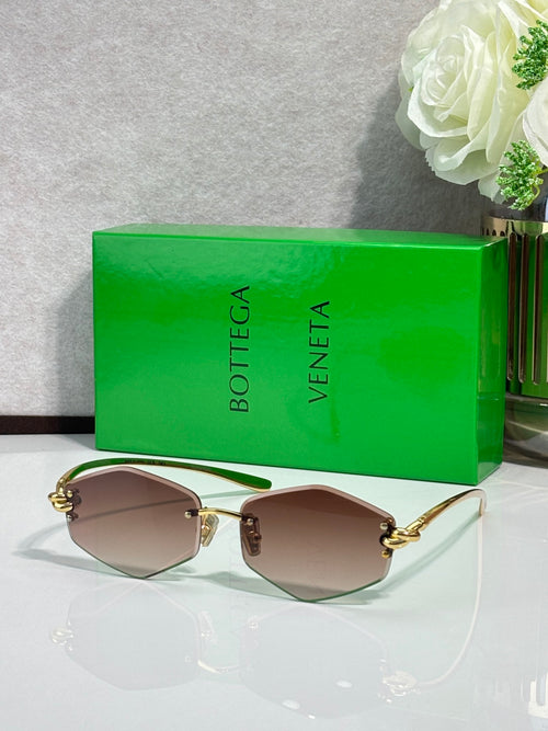 Gold-tone metal sunglasses with brown lenses and light temple tips