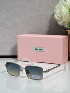 Gold-tone aviator sunglasses with blue-gray lenses and black temple tips