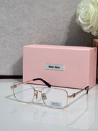 Gold-tone rectangular eyeglasses with clear lenses and black temple tips