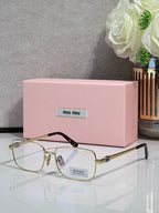 Gold-tone rectangular eyeglasses with clear lenses and black temple tips