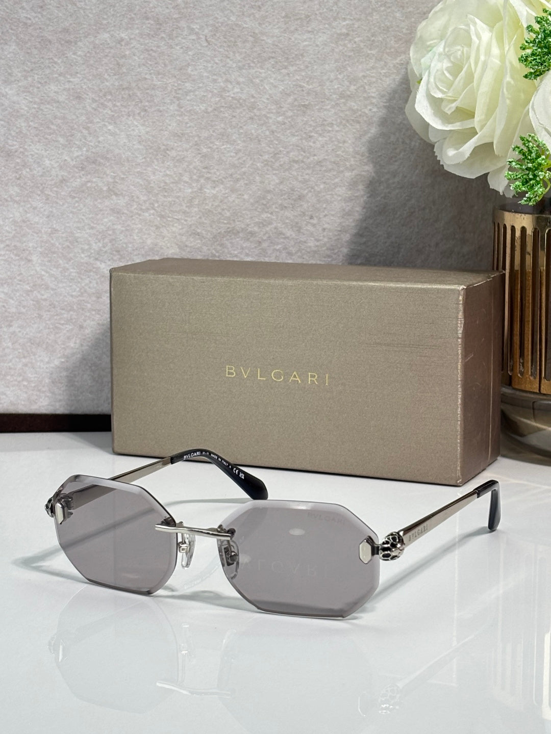 Hexagon sunglasses with gray lenses, silver-tone frame and dark blue temples