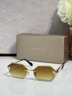 Hexagon sunglasses with yellow-tinted lenses, gold-tone frame and dark blue temples