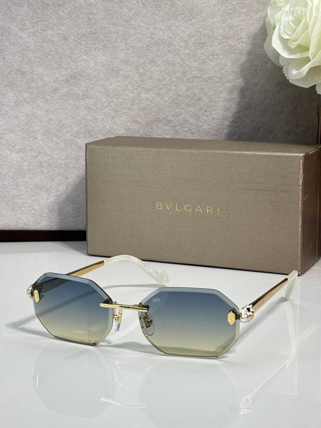 Hexagon sunglasses with light blue lenses, silver-tone frame and dark blue temples