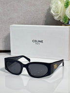 Celine sunglasses, black frame with dark oval lenses and gold side logo