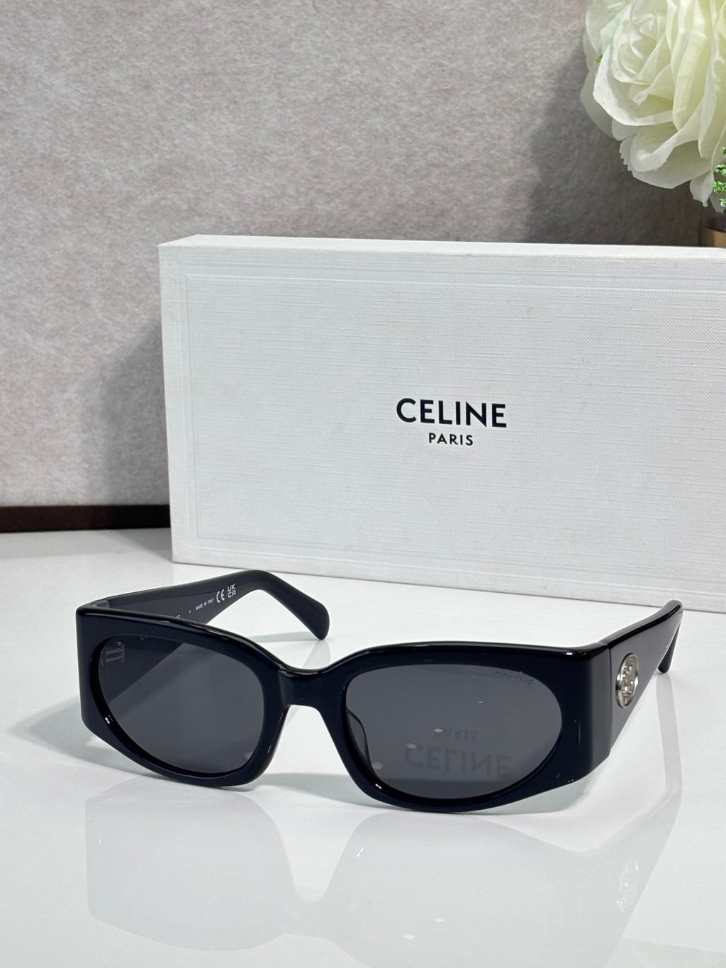 Celine sunglasses, black frame with dark oval lenses and gold side logo