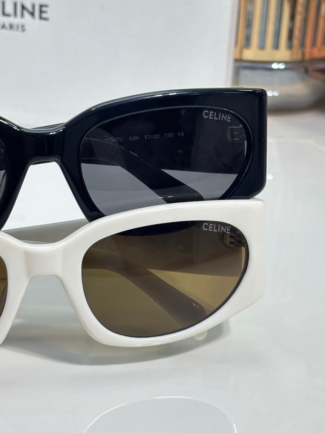 Celine sunglasses, white and dark frames side-by-side with tinted oval lenses