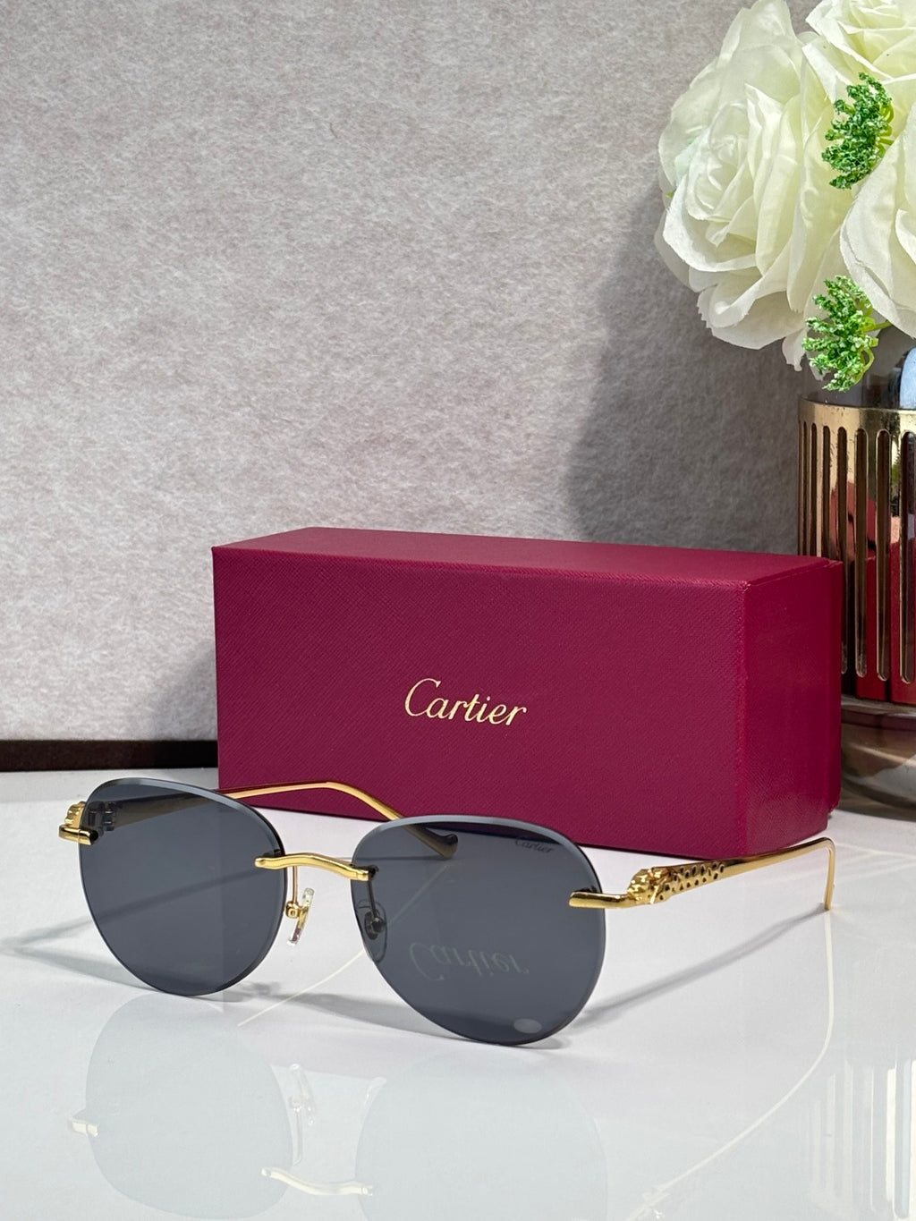 Cartier sunglasses with gold-tone frame and dark gray gradient lenses