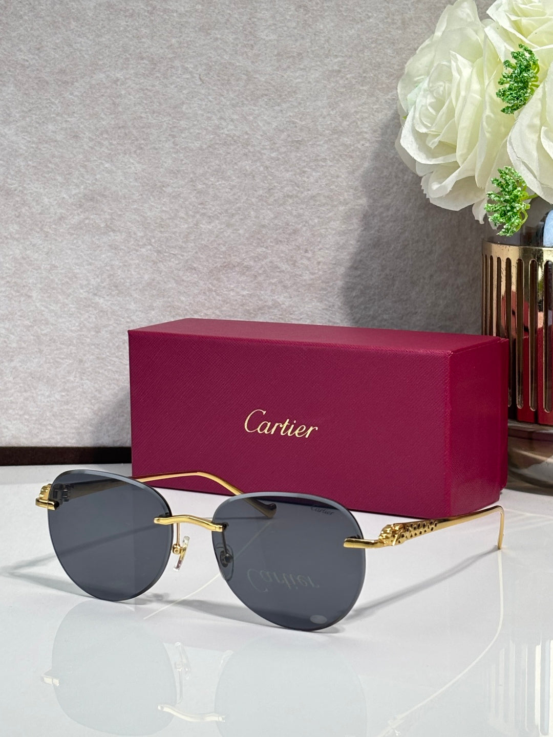 Cartier sunglasses with gold-tone frame and dark gray gradient lenses