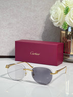 Cartier sunglasses with gold-tone frame and blue-gray gradient lenses