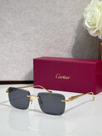 Cartier glasses with gold-tone frames and dark gray lenses, with burgundy box