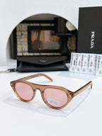 Prada sunglasses with tortoiseshell acetate frames and pink-tinted lenses, metal temple tips.