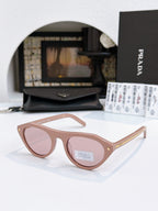 Prada sunglasses with tortoiseshell acetate frames and pink-tinted lenses, minimal metal detail.