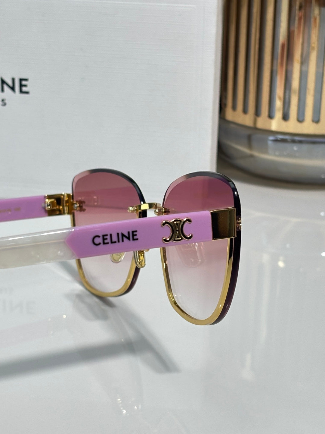 Celine sunglasses, close-up, pink-lilac lenses with gold-tone frame