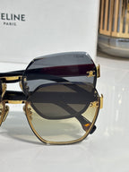 Celine sunglasses close-up: dark-tinted lenses with gold frame and temple logo detail