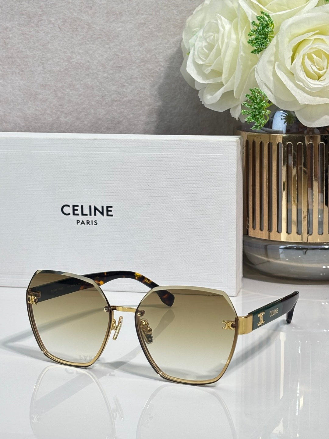 Celine sunglasses with light amber-tinted lenses and gold-tone frame, rounded square