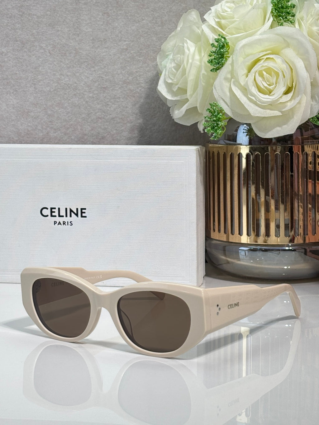 Celine cream sunglasses with rounded frames and dark lenses