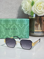 Gucci hexagon sunglasses with dark lenses and gold-tone metal frame