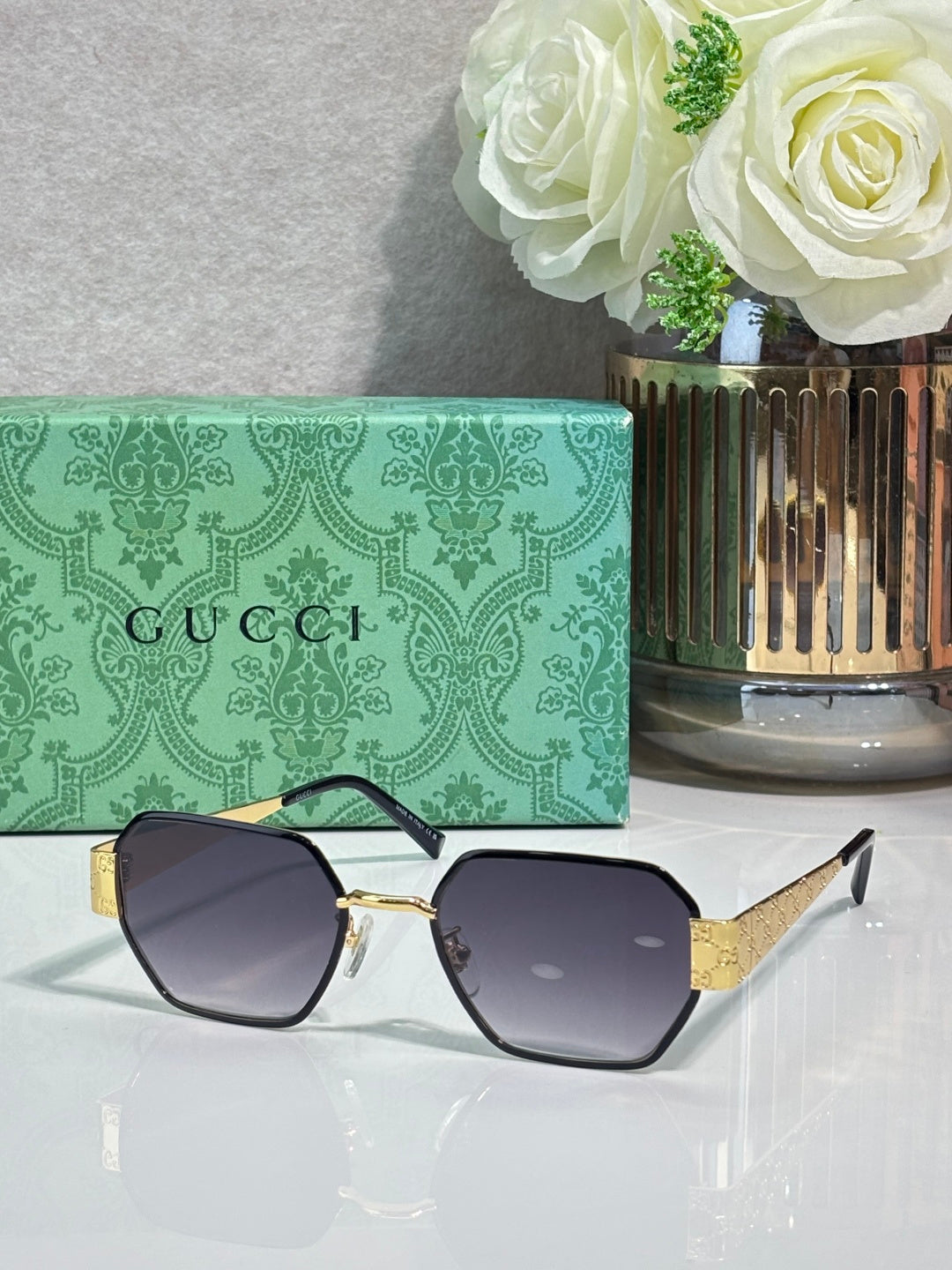 Gucci hexagon sunglasses with dark lenses and gold-tone metal frame