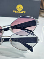 Versace sunglasses close-up with pink-tinted lens and metal logo arms