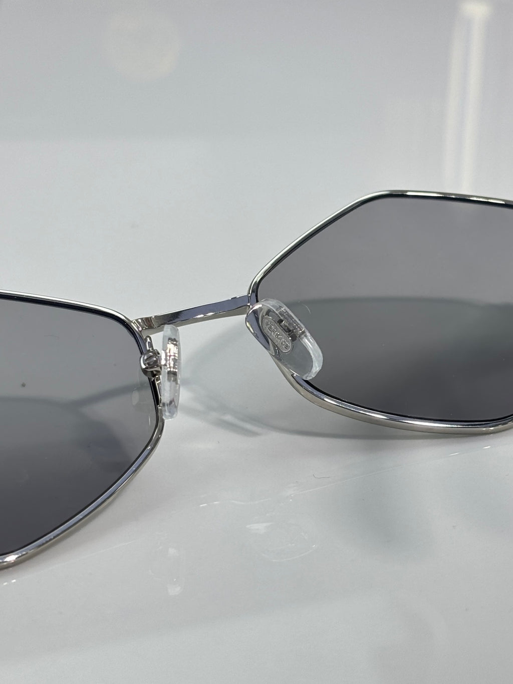 Versace sunglasses close-up of temple and gray-tinted lens