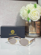 Versace octagonal sunglasses with gold-tone frames and mauve-tinted lenses