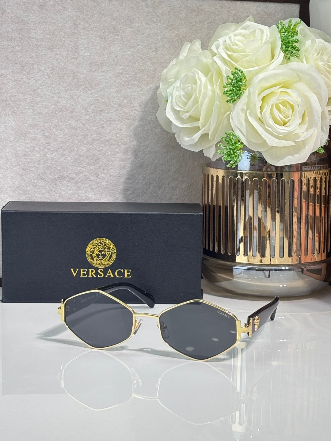 Versace octagonal sunglasses with gold-tone frames and dark-tint lenses