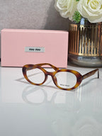 MiuMiu eyeglasses with tortoiseshell brown acetate frame and round optical lenses