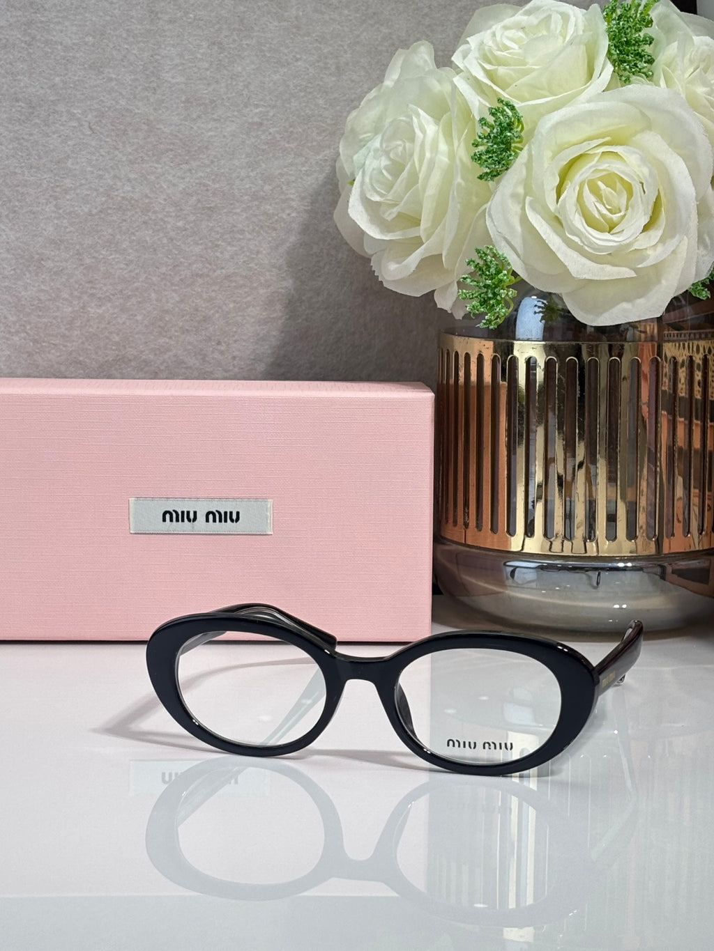 MiuMiu eyeglasses with black acetate frame and round optical lenses