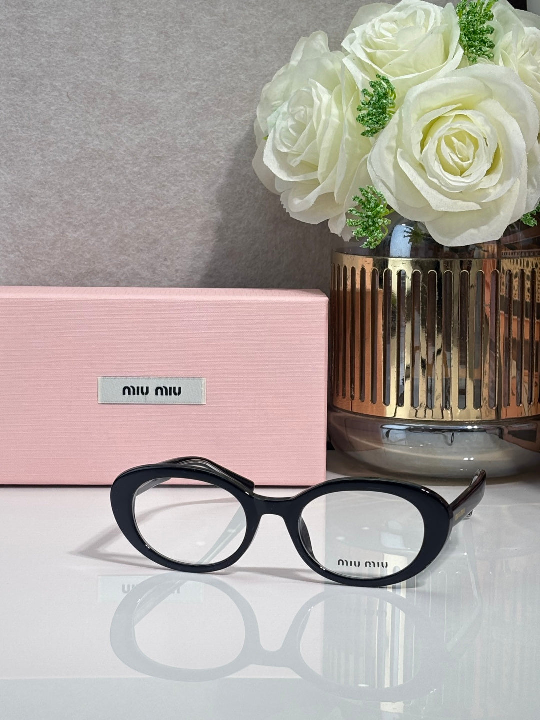 MiuMiu eyeglasses with black acetate frame and round optical lenses