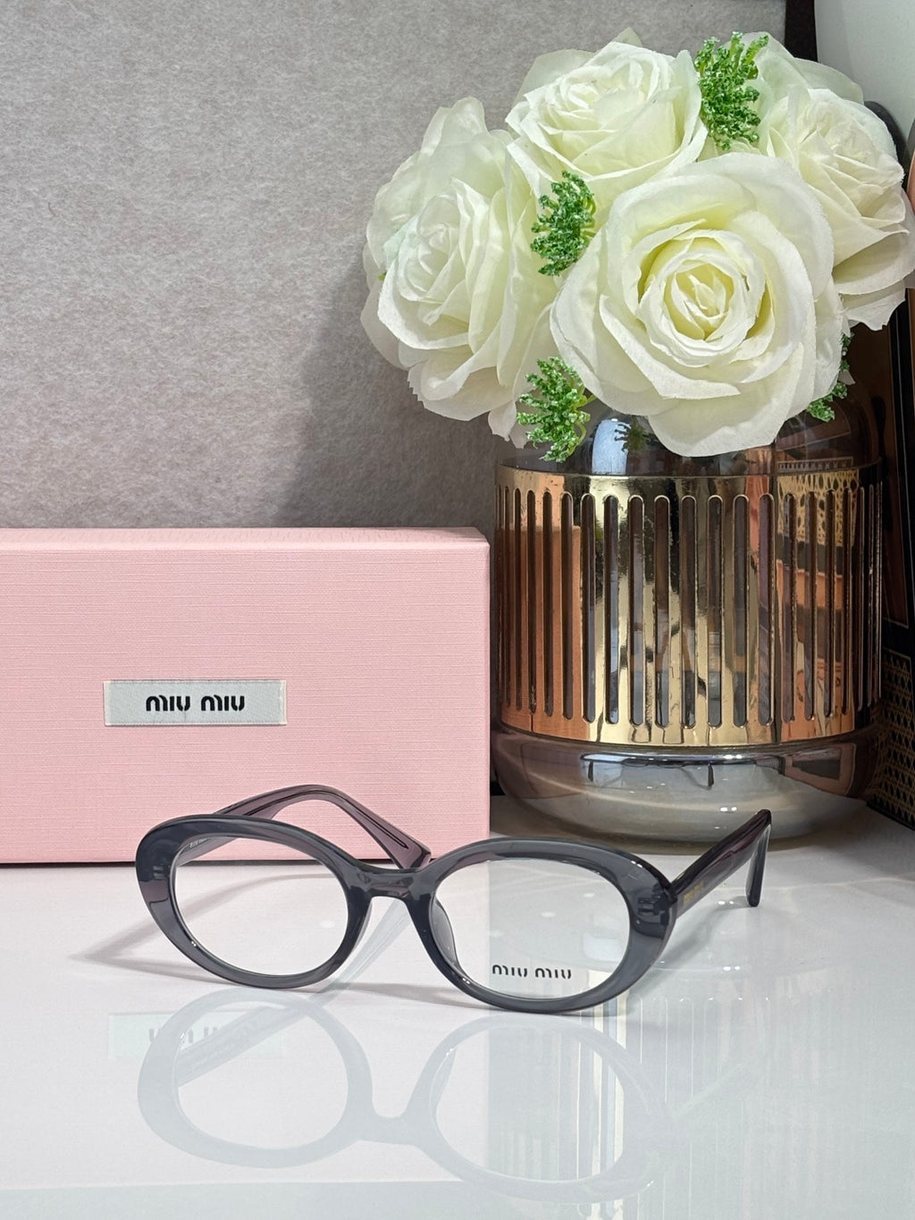 MiuMiu eyeglasses with dark blue acetate frame and round optical lenses