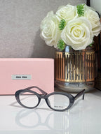 MiuMiu eyeglasses with dark blue acetate frame and round optical lenses