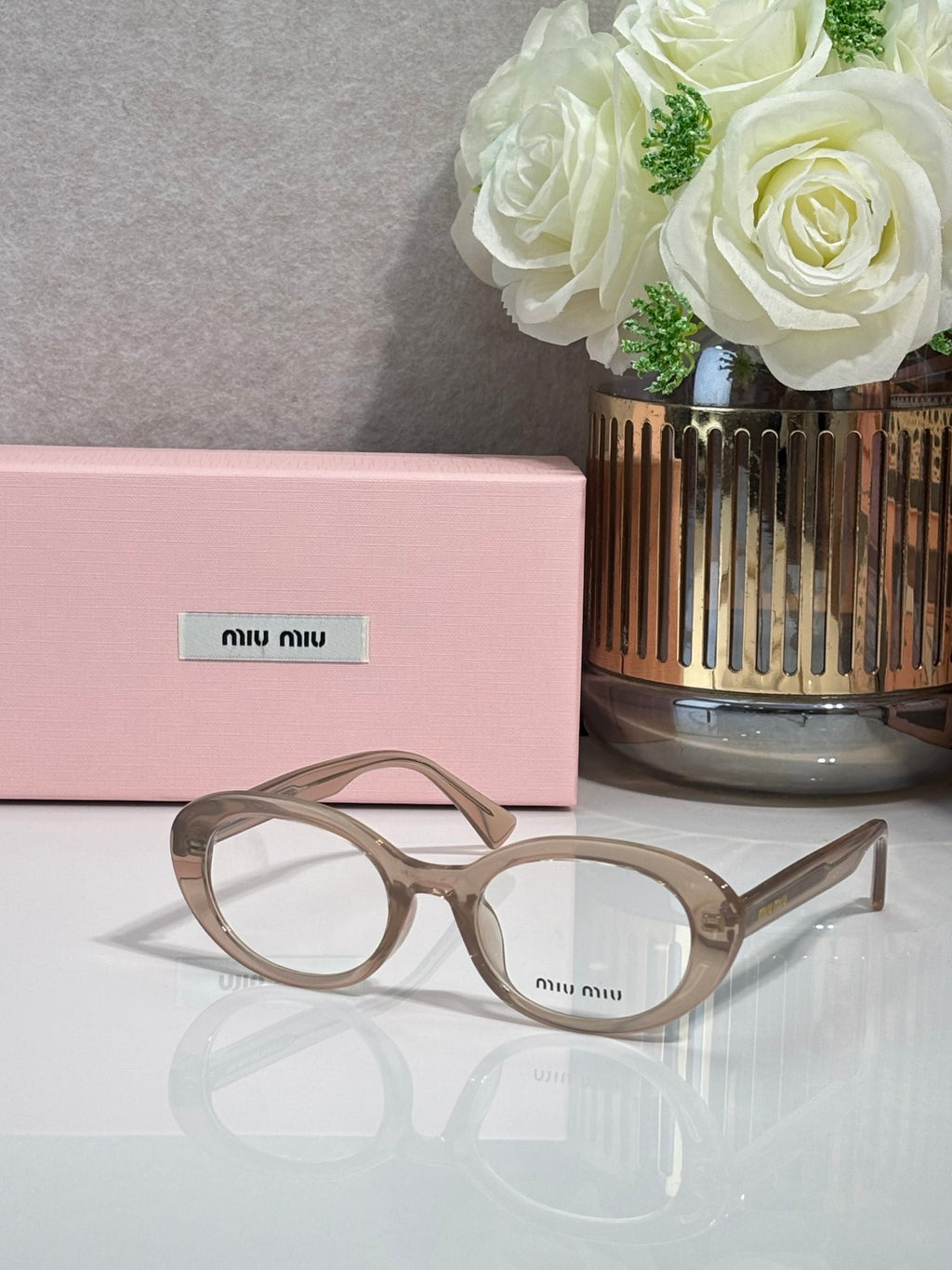 MiuMiu eyeglasses with light taupe translucent frame and round optical lenses