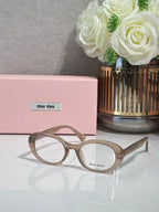 MiuMiu eyeglasses with light taupe translucent frame and round optical lenses