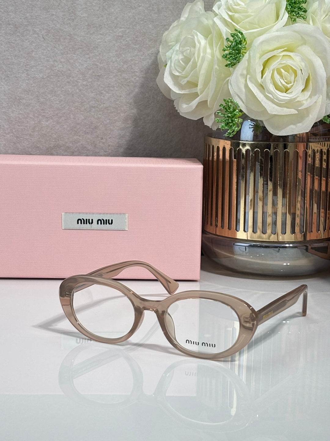MiuMiu eyeglasses with light taupe translucent frame and round optical lenses