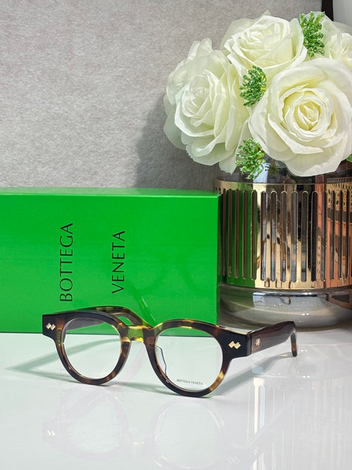 Bottega Veneta glasses with dark tortoiseshell frames and green accents