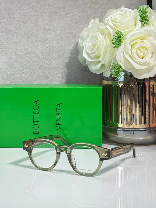 Bottega Veneta glasses with dark frames and light green temple accents