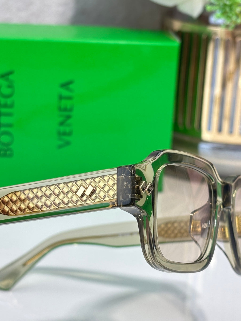 Bottega Veneta silver glasses with gold patterned temple and clear front lenses