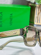 Bottega Veneta silver glasses with gold patterned temple and clear front lenses